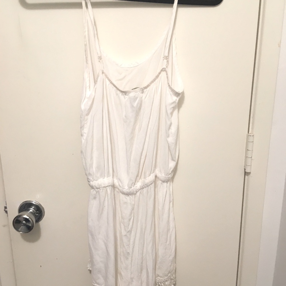 White romper, strings attach with metal clips.